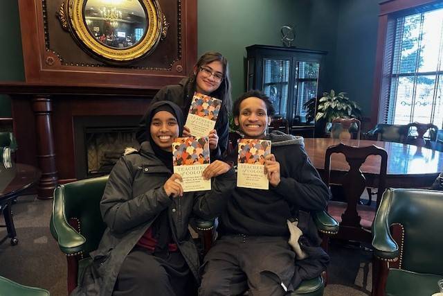 Group of Educators of Color Network students holding up books